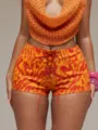 Detailed close-up view of sexy high-waisted lace-up tie-dye shorts and summer knit top. - S / Bottoms / Orange Red