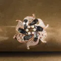 Exquisite rose gold flower brooch detail, sparkling crystal rhinestones and dark teardrop stones. - Gray