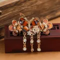Medium vintage butterfly hair claw clip with crystal rhinestones and elegant dangling chains. - Butterfly Tassel Hair Claw / Champagne