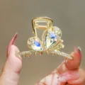 Crystal bow hair claw clip with colorful rhinestones, exquisite metal hair accessory detail. - Silver Gold White
