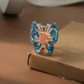 Rose gold butterfly hair claw clip with sparkling blue rhinestones for women hair styling. - Blue