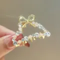 Golden rhinestone hair claw clip with bow design, elegant metal hair accessory for women ponytail. - CHY53
