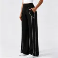 Pantaloni da yoga sportivi larghi a vita alta da donna con profili a contrasto e tasche. - Taglia S / Nero