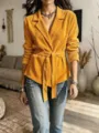 Detailed view of the stylish yellow corduroy blazer featuring a chic belted waist and lapel. - S / Tops / Orange
