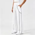 Women's white high-waisted wide-leg athletic casual pants with contrast black piping. - White