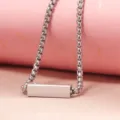 Detail shot of minimalist silver metal bar pendant necklace with box chain link design. - Steel