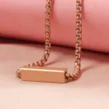 Rose gold blank bar pendant necklace detail, minimalist design for custom engraving, closeup view. - Rose Gold