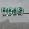 Four-key mechanical switch keychain glowing stress relief toy clear acrylic base pendant. - With LED Lights / 4-Grid Green