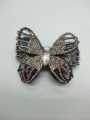 Detailed view of a sparkling butterfly hair clip decorated with colorful rhinestones. - Champagne