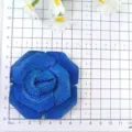 Detailed close-up view of the sparkling blue rhinestone layered rose flower craft accessory. - Dark Blue