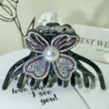 Detailed close-up of a luxury rhinestone hair claw clip with a large pearl centerpiece. - Iridescent Rhinestones