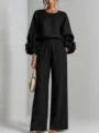 Elegante completo nero da donna con top a maniche lunghe con dettagli floreali e pantaloni larghi - XS / Top e Pantaloni / Nero