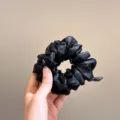 Black sparkly sheer tulle hair scrunchie accessory elegant daily styling detail shot - Black
