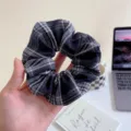 Close up view of the black and white plaid fabric hair scrunchie showing fine texture. - L / Navy Blue