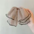 Sheer chiffon hair bow clip detail shot, elegant beige hair accessory for women styling. - Khaki