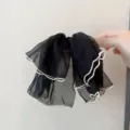 Détail nœud de cheveux en mousseline noire, tissu léger et transparent avec bordure festonnée. - Noir