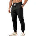 Primo piano dettagliato di pantaloni sportivi neri da uomo con comoda vita elastica. - Taglia S / Pantaloni e gonne / Nero