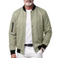 Detailed view of men's faux suede bomber jacket with ribbed cuffs and snap button closure. - S / Tops / Light Green