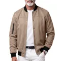 Close-up detail of men khaki faux suede bomber jacket with snap buttons and cuffs. - Brown