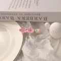 Close-up detail of the sweet pink flower hair clip, featuring delicate floral and bud design. - Light Pink