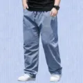 Close-up view of casual loose-fit denim jeans showing fabric texture and straight leg cut. - 28 / Bottoms / Light Blue