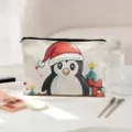 Close-up detail of the polyester christmas penguin cosmetic bag on white table with makeup setup. - Purple Embroidery (05)