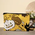 Close-up detail of Halloween makeup bag featuring cute pumpkin and black cat print design. - 04