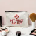 Detailed shot of white canvas pet first aid kit storage bag with red cross and paw print design. - Pet First Aid Kit Theme (05)
