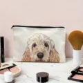 Canvas makeup bag featuring a cute fluffy dog illustration closeup on a stylish vanity desk. - Pet Dog Illustration Style (05)