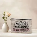 Detail view of canvas cosmetic bag with godmother Spanish quote print and secure black zipper. - 05