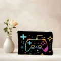 Detail view of black cosmetic pouch featuring colorful game controller print, zipper closure. - Game Controller Neon Style