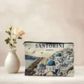 Detailed view of a portable cosmetic bag featuring a scenic Santorini Greece print design. - 04