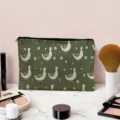 Detailed view of dark green cosmetic bag featuring cute duck and daisy print with black zipper. - Cartoon White Duck and Daisy Pattern / Dark Green