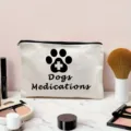 Detailed view of white canvas zipper pouch featuring paw print and text, ideal for pet supplies. - Off-White (Dogs Medications Print)