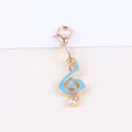 Gold-tone alloy lobster clasp charm with blue enamel treble clef pendant and crystal detail. - Music Note