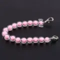 Nahaufnahme Detail des rosa Perlen Handy Ketten Anhängers mit zwei Metall Karabiner. - Weißgold Karabinerverschluss / Rosa