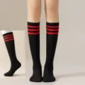 Detail view of black knee high socks featuring three red stripes at top for JK style wear. - One Size / Black with Red Stripes Calf Socks