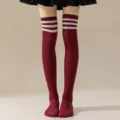 Close-up detail of burgundy over-the-knee socks with white three stripes, preppy JK style. - One Size / Wine Red with White Stripes