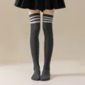 Detailed view of dark grey over-the-knee socks featuring classic white triple stripe design. - One Size / Dark Grey with White Stripes