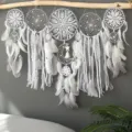 Handcrafted white dream catcher wall hanging with feathers, lace tassels, and wooden beads. - Gray