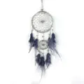 Detailed close-up of handmade feather dreamcatcher wall hanging home decor ornament. - Gray