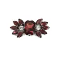 Close-up detail of sparkling dark red and clear glass rhinestone shoe buckle and DIY craft accessory. - Deep Red Rhinestone Style