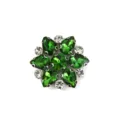 Close-up detail of green crystal rhinestone floral patch with shiny silver metal base. - Style 17