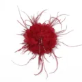 Close up detail of red fabric flower accessory with feather and rhinestone beaded fringe. - Red