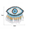 Gedetailleerd overzicht van handgemaakte kraal boze oog patch, DIY kledingaccessoires applicatie. - Maat 7