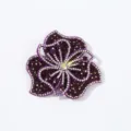 Close-up detail of purple 3D rhinestone flower patch, sparkling crystal applique for DIY clothing. - Deep purple