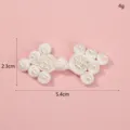 Detailed shot of white Chinese traditional handmade frog button with faux pearls, 5.4x2.3cm. - Style 7