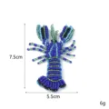 Detailed close-up view of the handmade blue beaded lobster patch with vibrant colorful sequins. - Lobster 1 Style