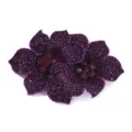Close-up detail of double flower rhinestone shoe flower patch apparel accessory. - Deep purple