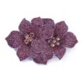 Detailed close-up of a double rhinestone flower shoe clip, sparkling purple crystals DIY accessory. - Purple
